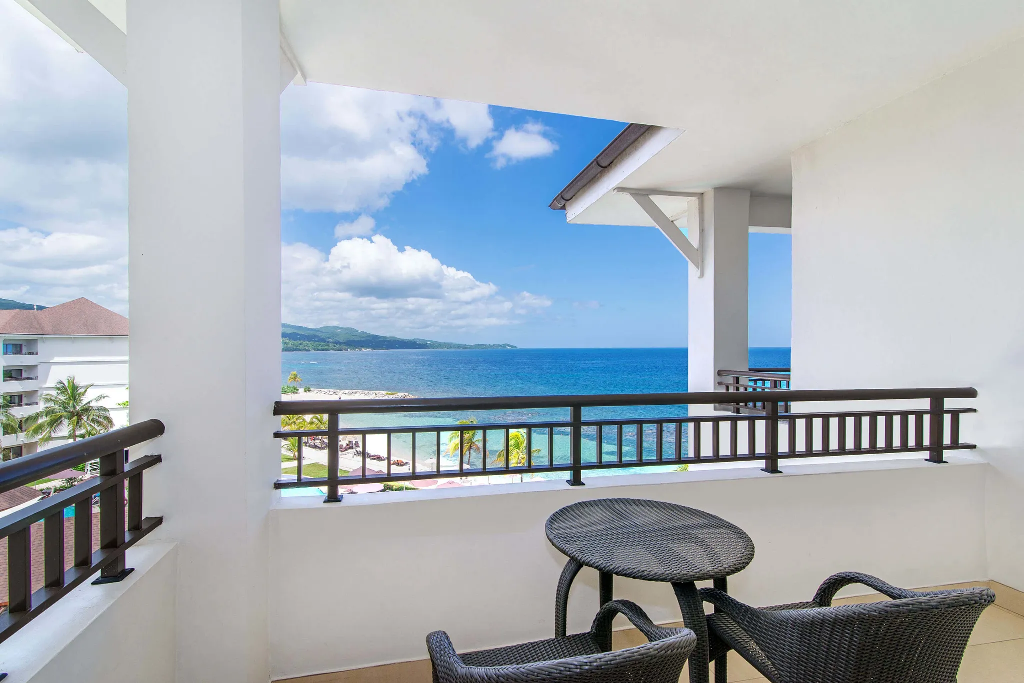 Junior Suite Ocean View private balcony with Caribbean Sea views at Secrets Wild Orchid Montego Bay.