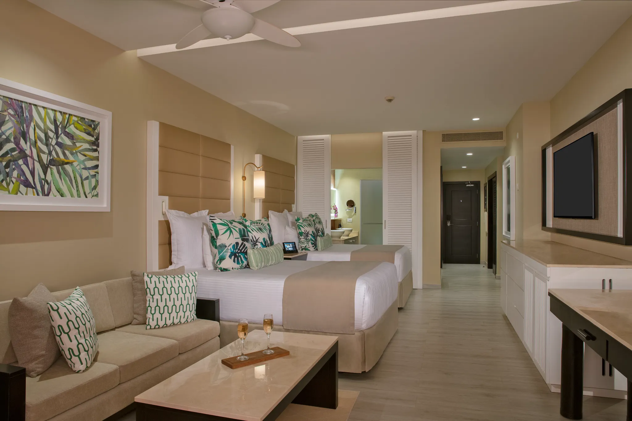Junior Suite Ocean View with two queen beds and separate sitting area at Secrets Wild Orchid Montego Bay.