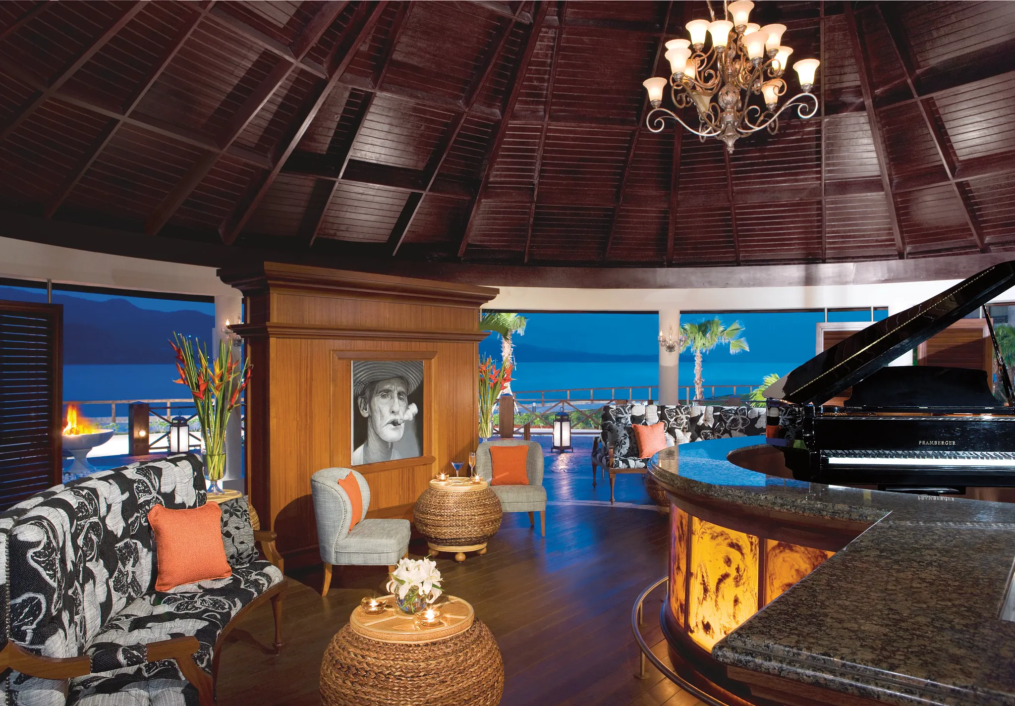 Piano Bar at Secrets Wild Orchid Montego Bay featuring Cuban-themed décor, grand piano, panoramic ocean views, and stylish lounge seating.