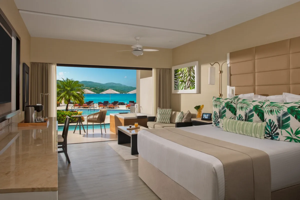 Preferred Club Junior Suite Ocean View Swim Out with king bed and direct pool access at Secrets Wild Orchid Montego Bay.
