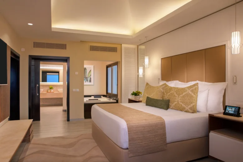 Preferred Club Master Suite Oceanfront bedroom with king-size bed at Secrets Wild Orchid Montego Bay.
