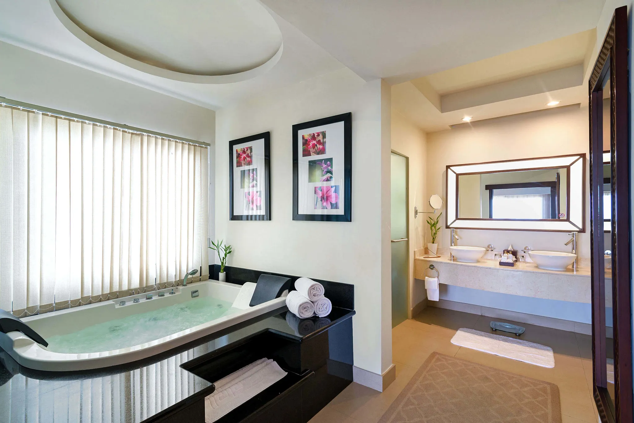 Preferred Club Presidential Suite bathroom with large hydrotub for four and dual vanities at Secrets Wild Orchid Montego Bay.