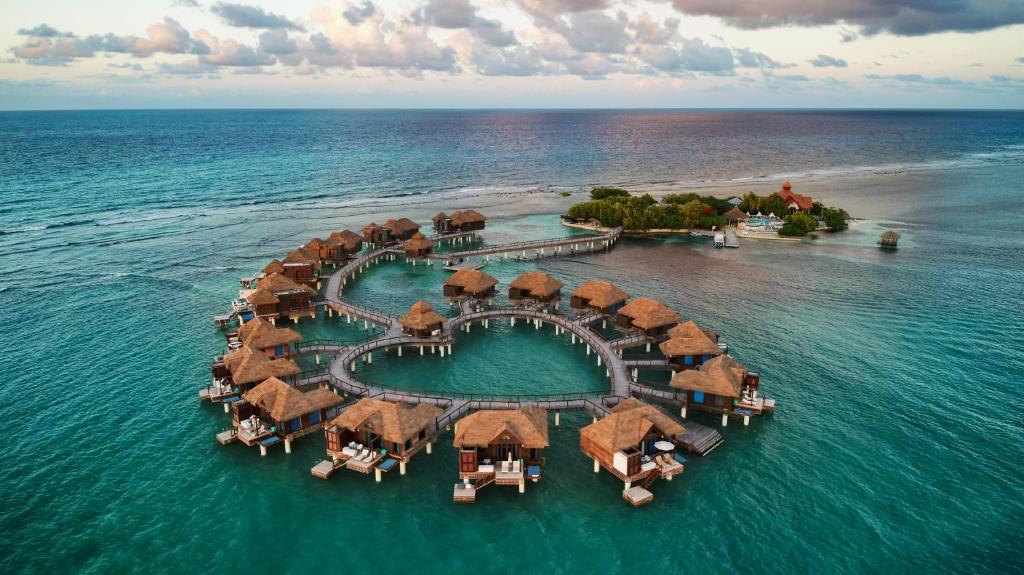 Sandals Royal Caribbean couples-only all-inclusive resort in Montego Bay Jamaica with private offshore island, overwater bungalows, and luxury amenities.