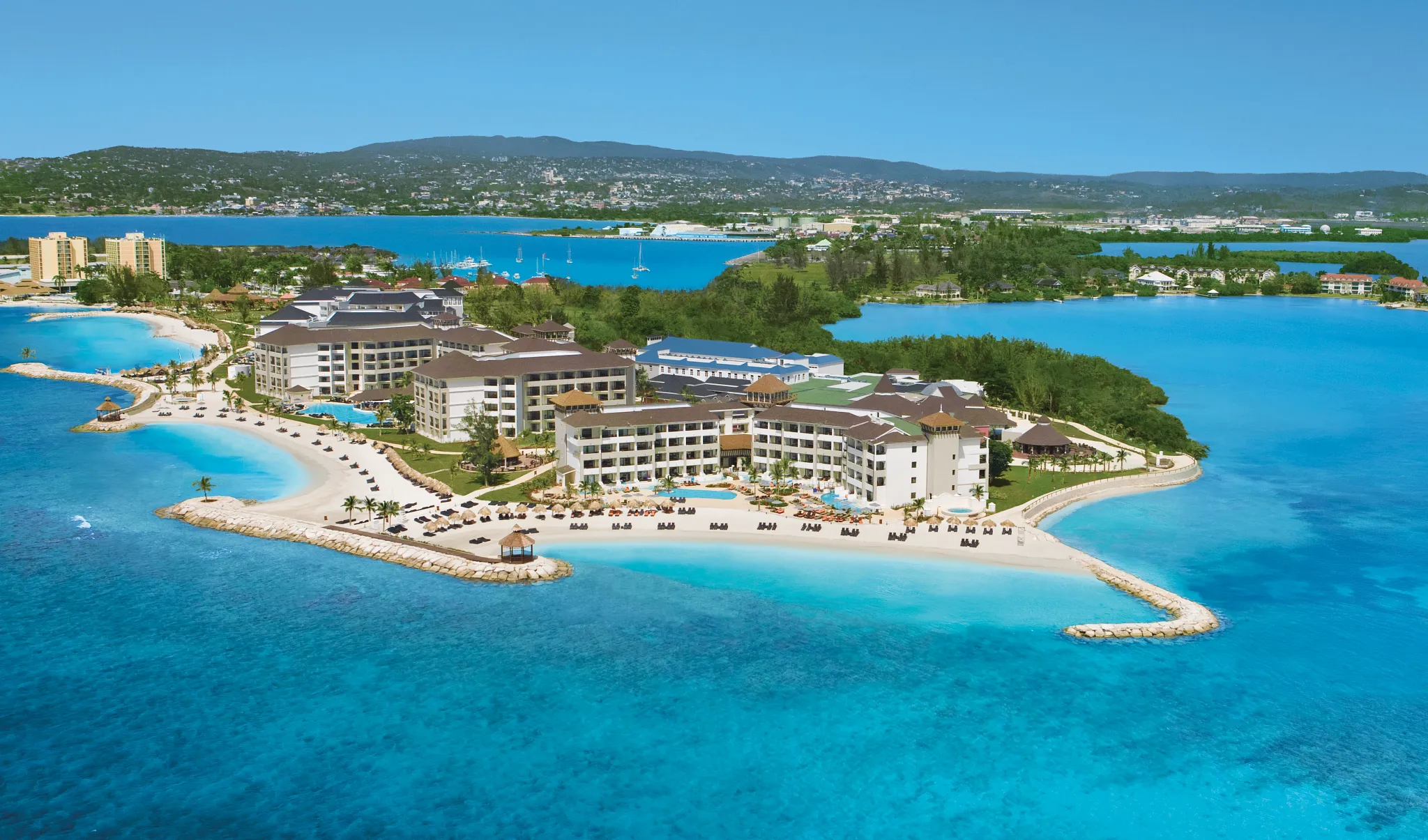 Aerial view of Secrets Wild Orchid Montego Bay on a private peninsula with turquoise Caribbean waters and white-sand beaches in Jamaica.